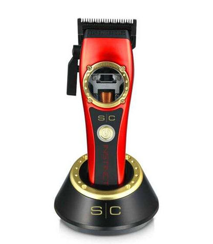 Red and black hair trimmer with gold accents on a white background